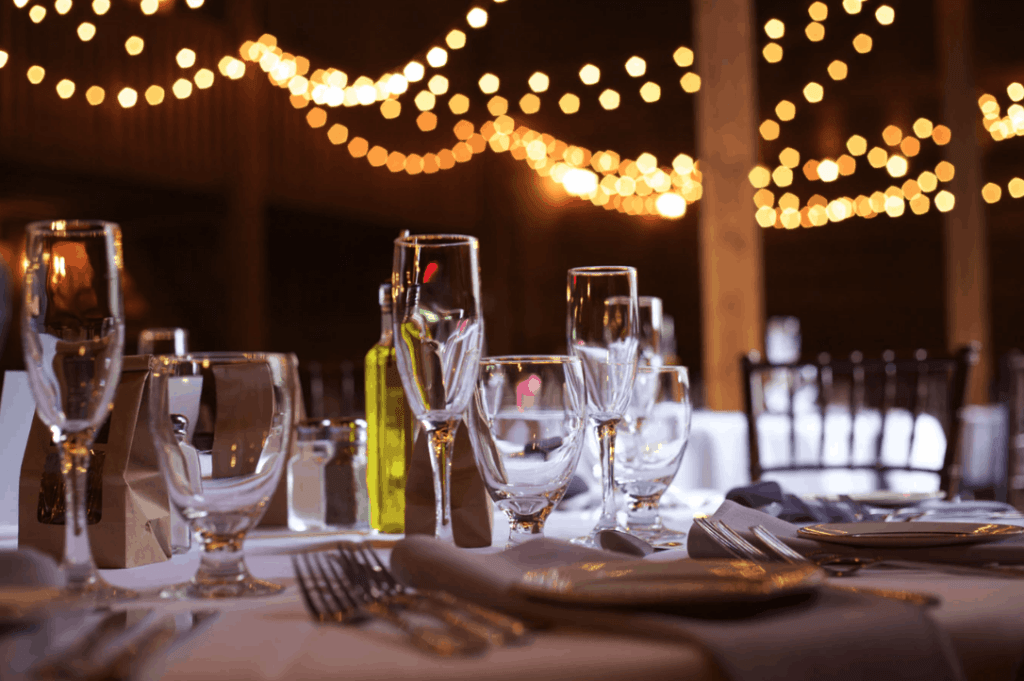 Summit City Rental shows an image of a barn wedding rental with glass rental, plate rental, and silverware rental.