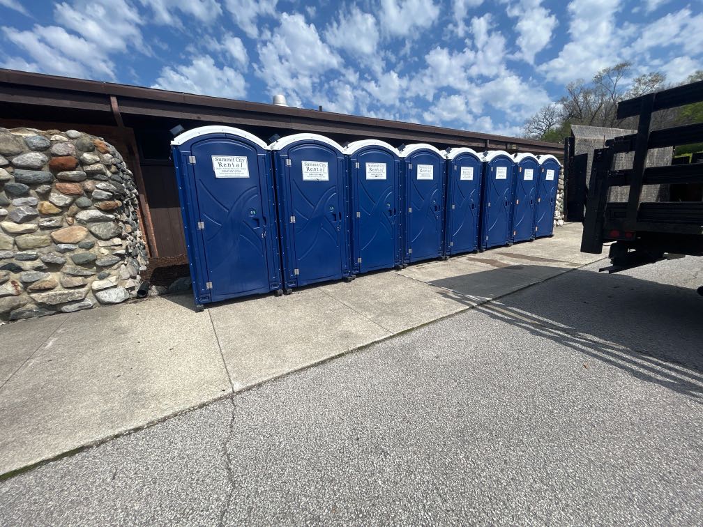 Portable Toilet Rental in Paulding, Ohio May 23, 2026 Row of portable restrooms outdoors by Summit City Rental in Paulding, Ohio.